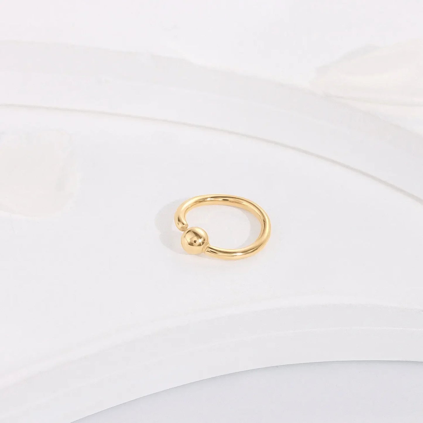 Minimalist gold fashion ring with a sphere design on a white background, Rosary Milano jewelry