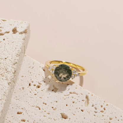 Moss agate ring with a round moss agate and three cz on each side gold promise ring