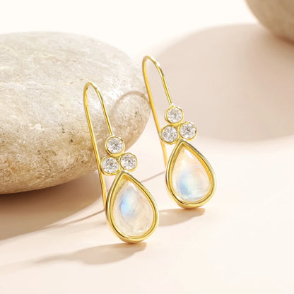 Gold moonstone earrings with teardrop moonstones and three clear diamond cz stones