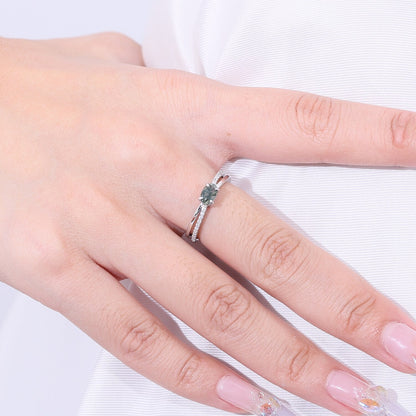 Moss agate wedding ring with a cross-shaped design in silver