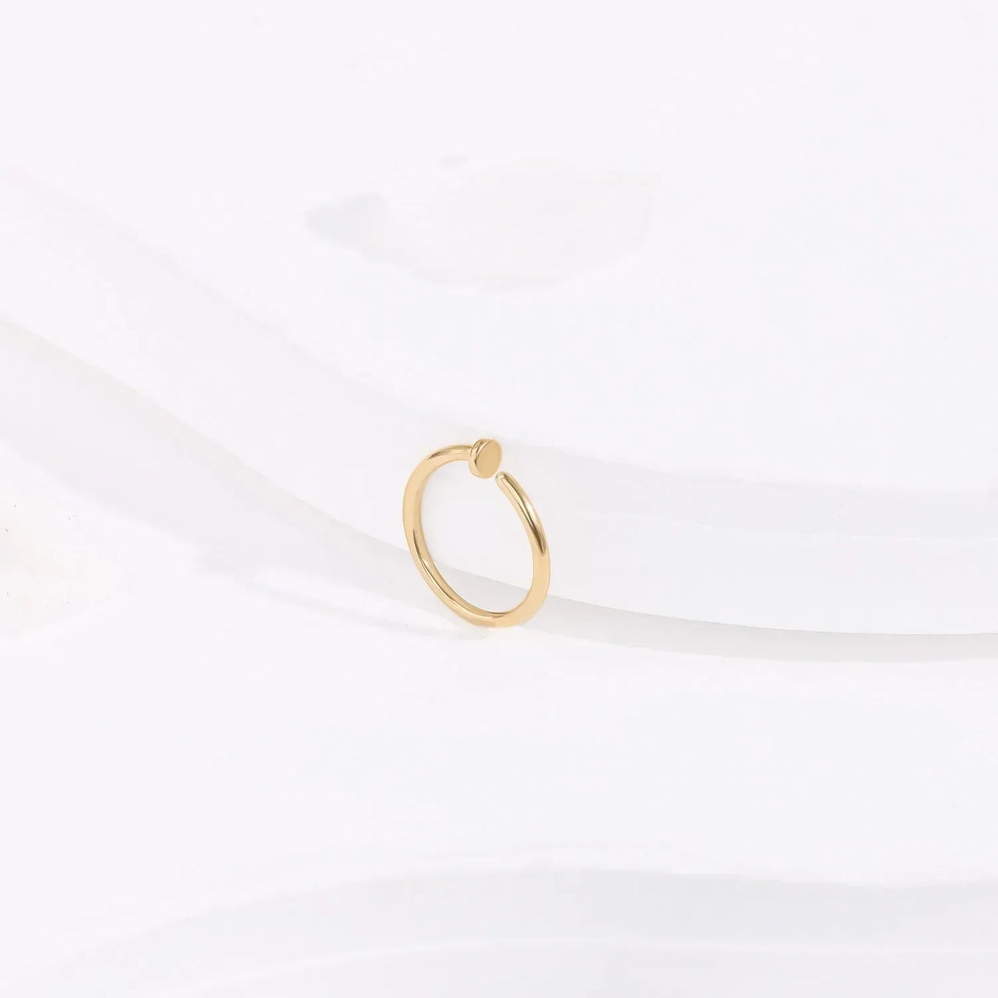 Minimalist gold ring with round accent on white background, Rosary Milano fashion jewelry