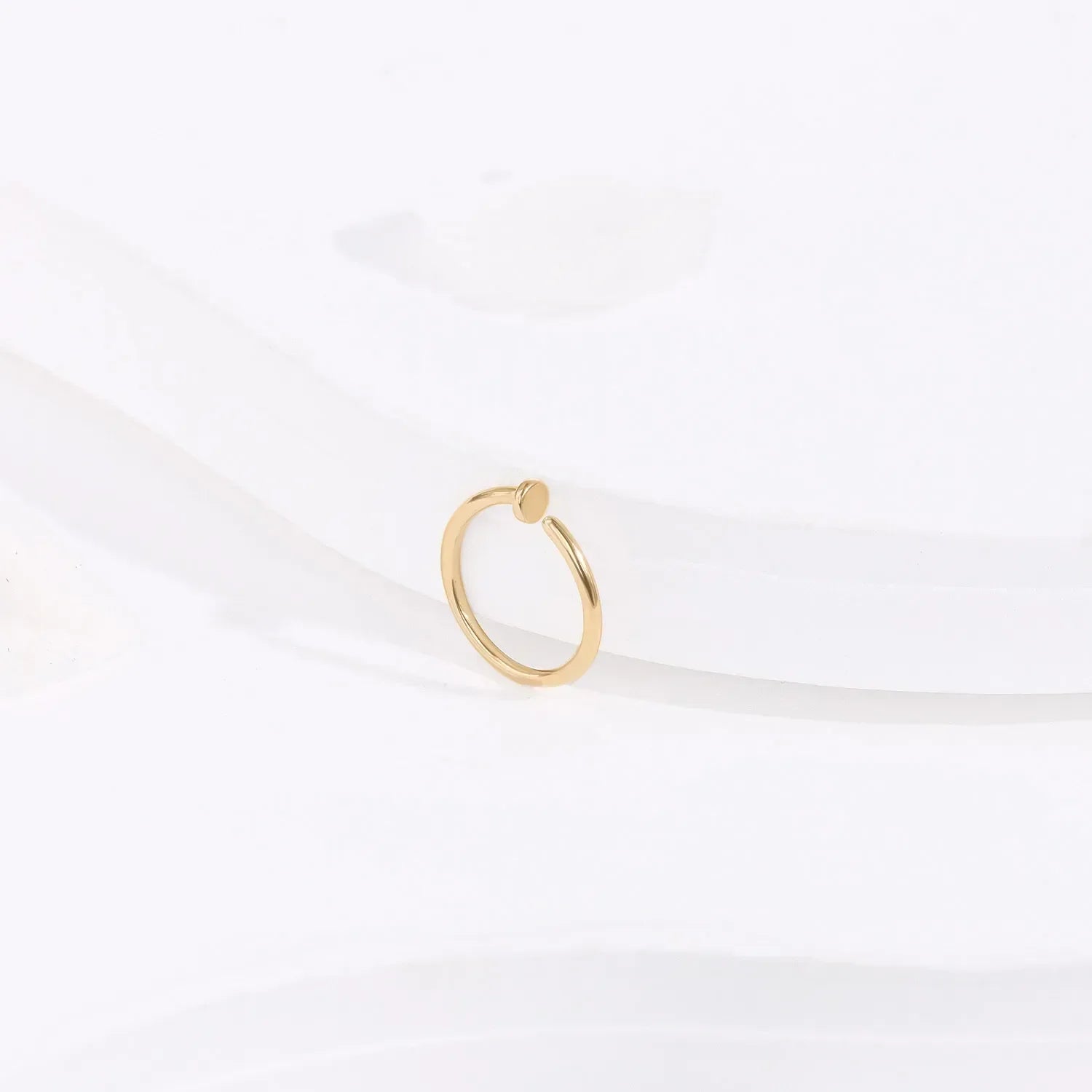 Minimalist gold ring with round accent on white background, Rosary Milano fashion jewelry
