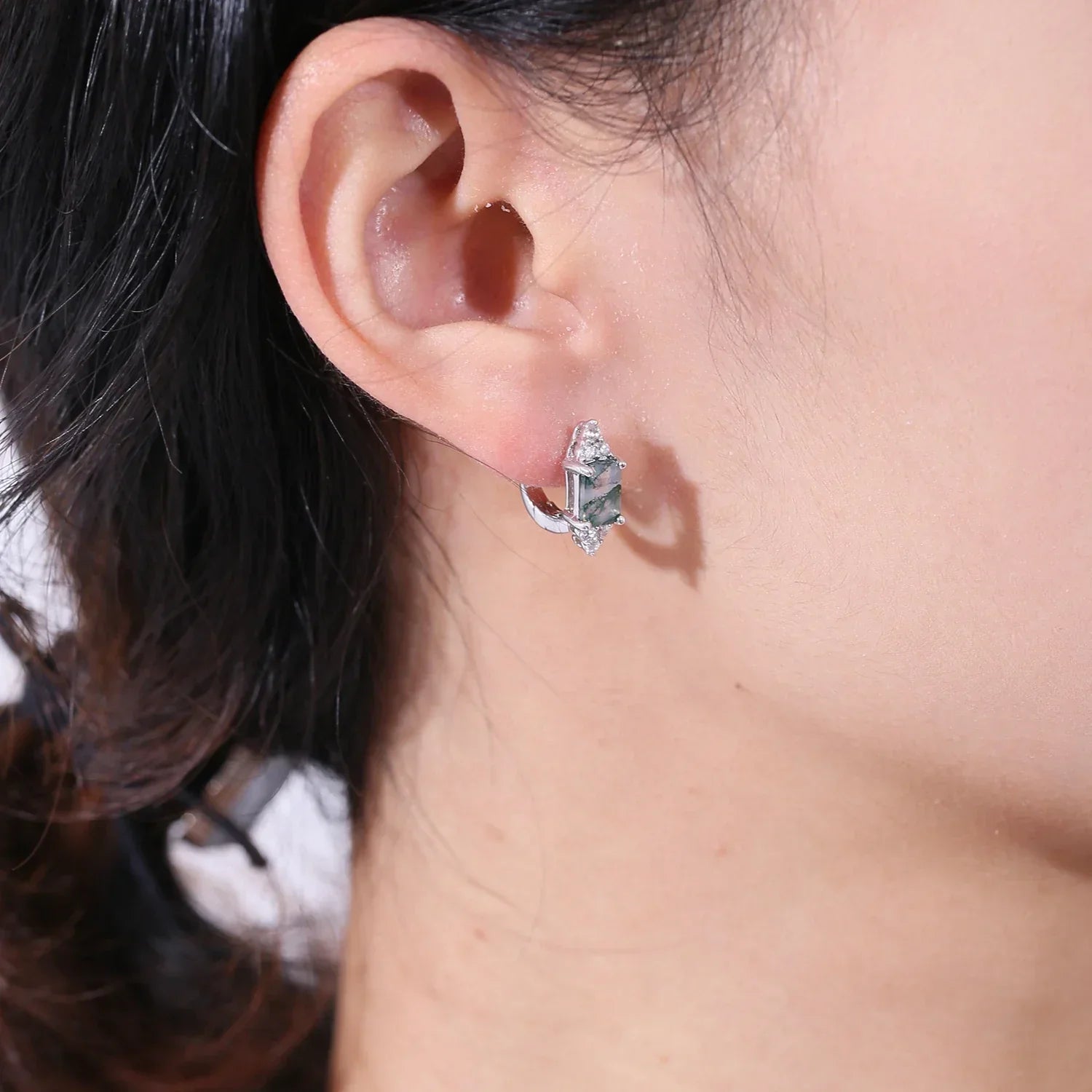 Silver and crystal fashion earring worn on woman's ear, Rosary Milano jewelry