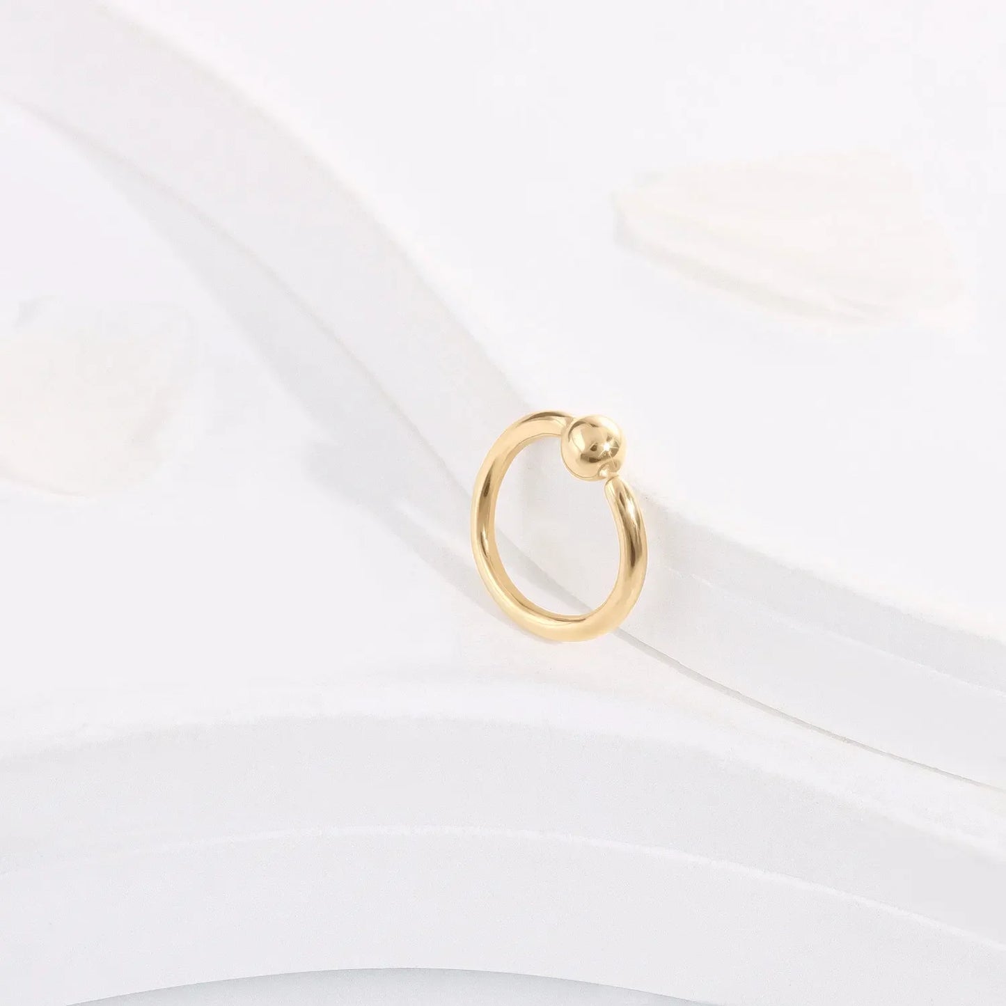 Minimalist gold hoop ring with bead accent on white background, Rosary Milano jewelry