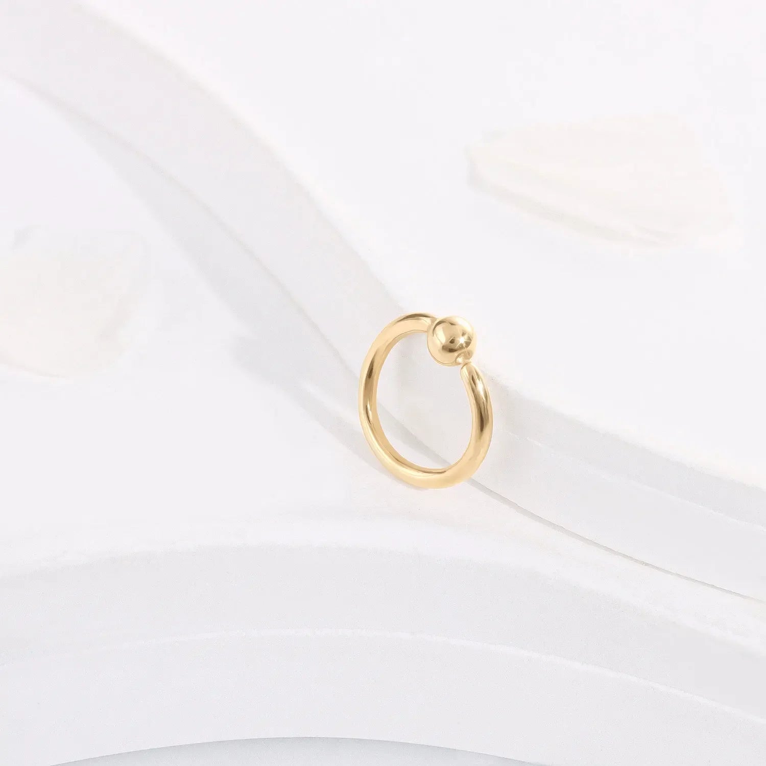 Minimalist gold hoop ring with bead accent on white background, Rosary Milano jewelry