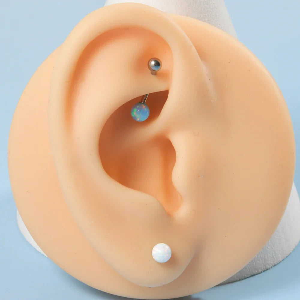 Barbell eyebrow piercing with opal titanium curved barbell