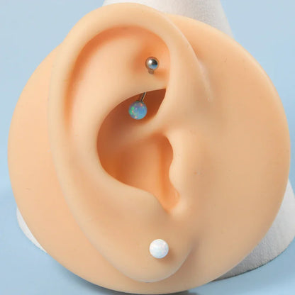 Barbell eyebrow piercing with opal titanium curved barbell