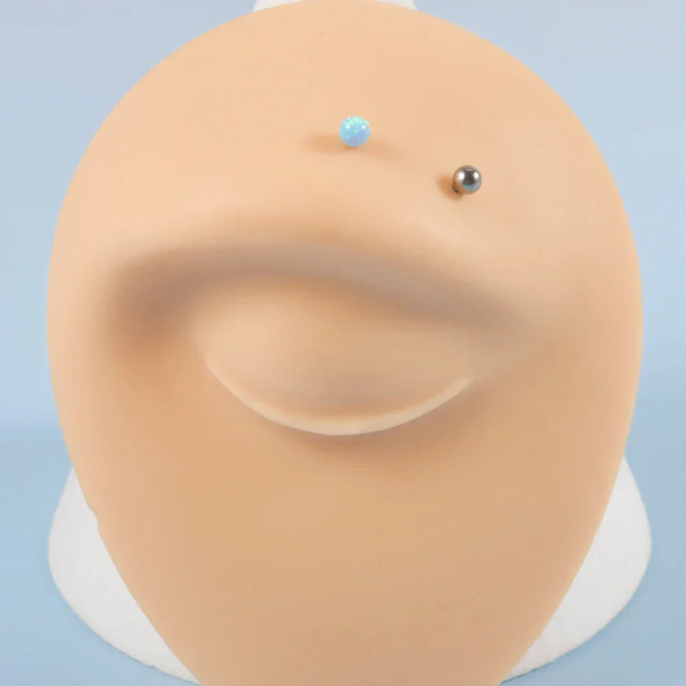 Barbell eyebrow piercing with opal titanium curved barbell