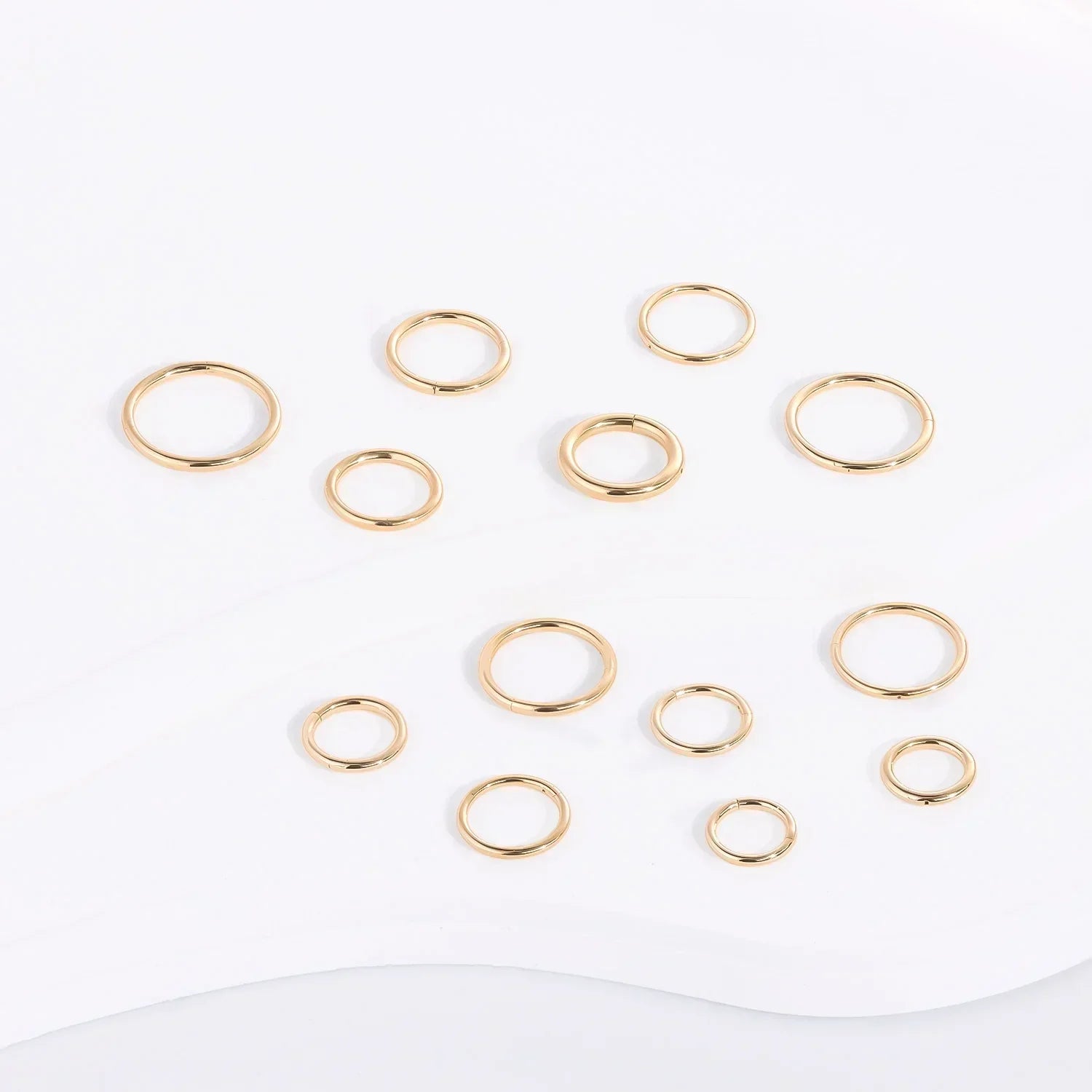 Assorted gold stacking rings displayed on a white background, Rosary Milano jewelry