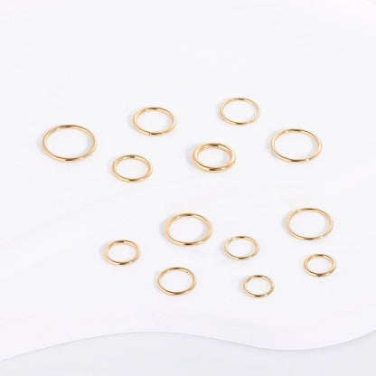 Assorted gold stacking rings displayed on a white background, Rosary Milano jewelry