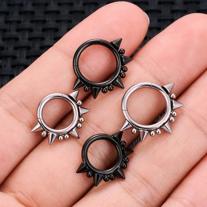 Black and silver spiked hoop earrings on hand, RosaryMilano fashion jewelry.