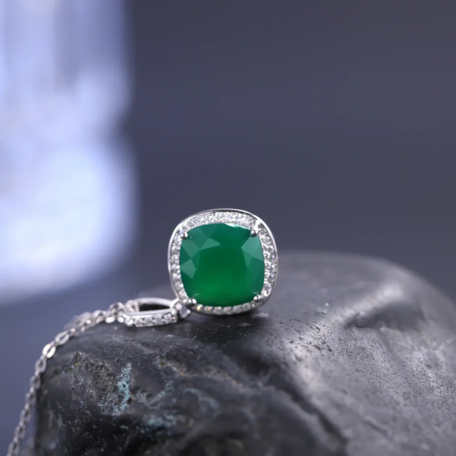 Elegant green gemstone pendant necklace with diamonds by RosaryMilano on a dark stone