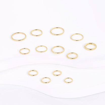 Gold minimalist rings set on white background, Rosary Milano fashion jewelry