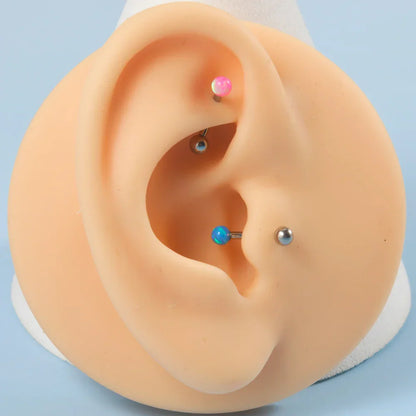 Barbell eyebrow piercing with opal titanium curved barbell