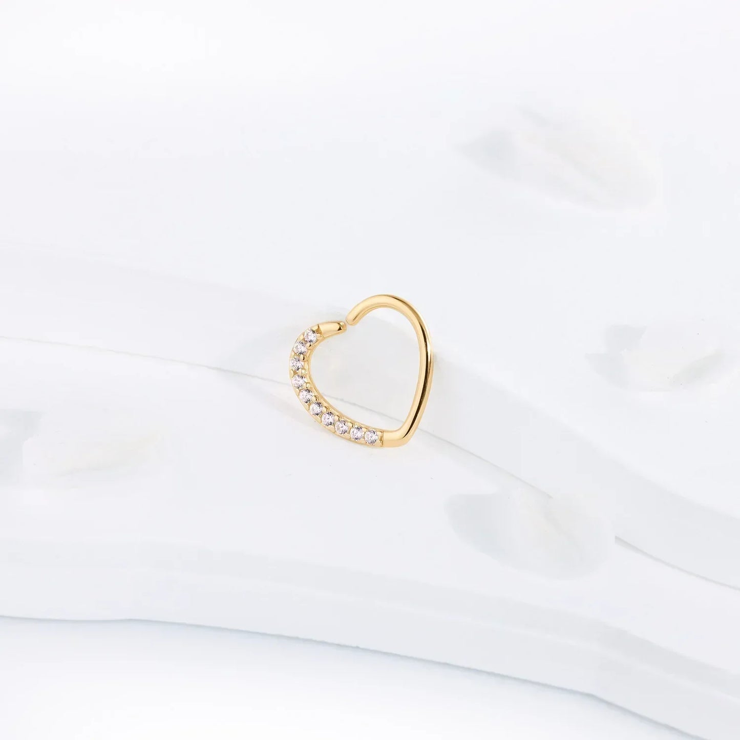 Gold heart-shaped earring with crystals on white background, Rosary Milano jewelry