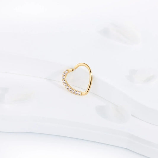 Gold heart-shaped earring with crystals on white background, Rosary Milano jewelry