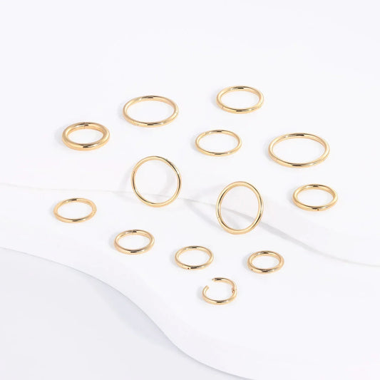 Rosary Milano gold fashion rings set on white background, minimalist jewelry display