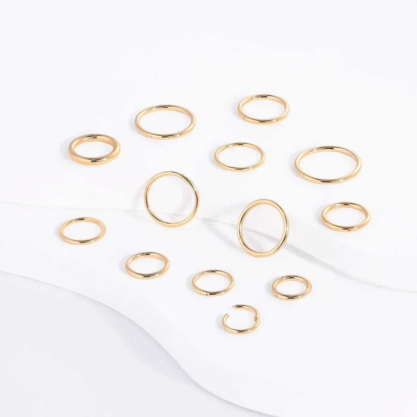 Gold minimalist rings set on white background, Rosary Milano fashion jewelry