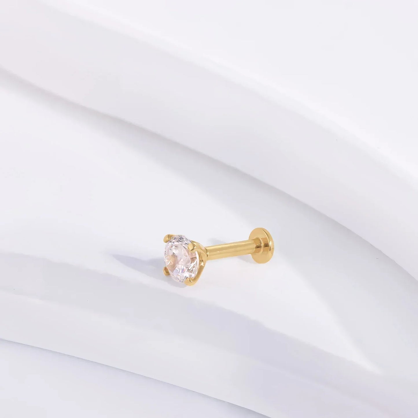Gold stud earring with clear gemstone by Rosary Milano on white background