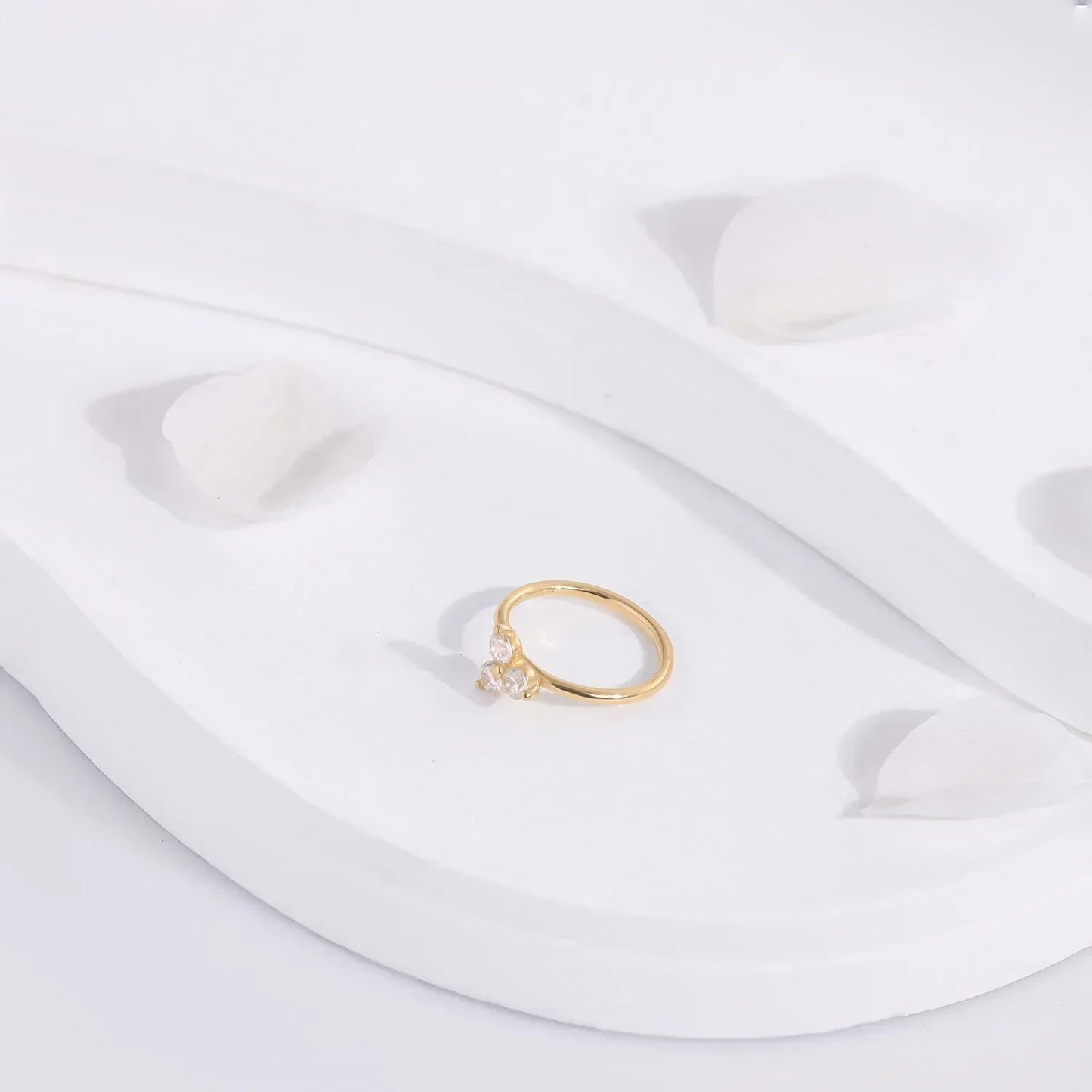 Gold ring with clear gemstones on white decorative surface, Rosary Milano fashion jewelry