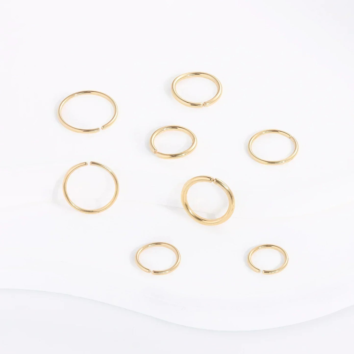 RosaryMilano gold fashion jewelry rings arranged on white background