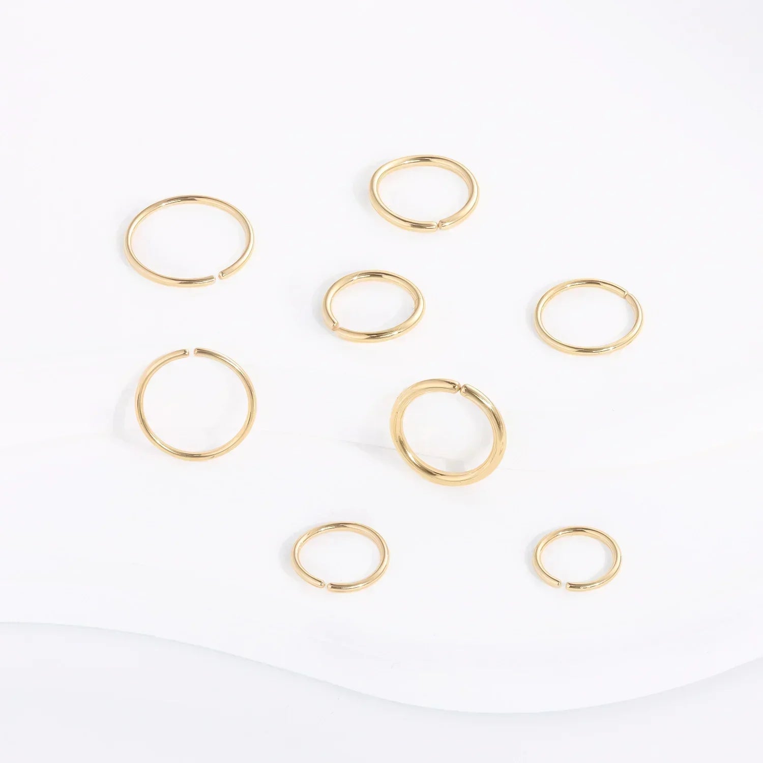 RosaryMilano gold fashion jewelry rings arranged on white background