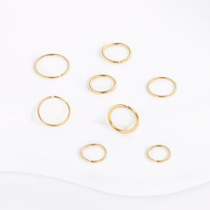 RosaryMilano gold fashion jewelry rings arranged on white background