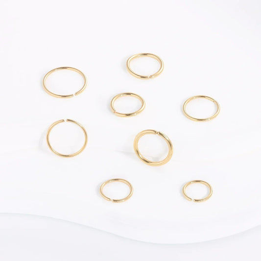 RosaryMilano gold fashion jewelry rings arranged on white background