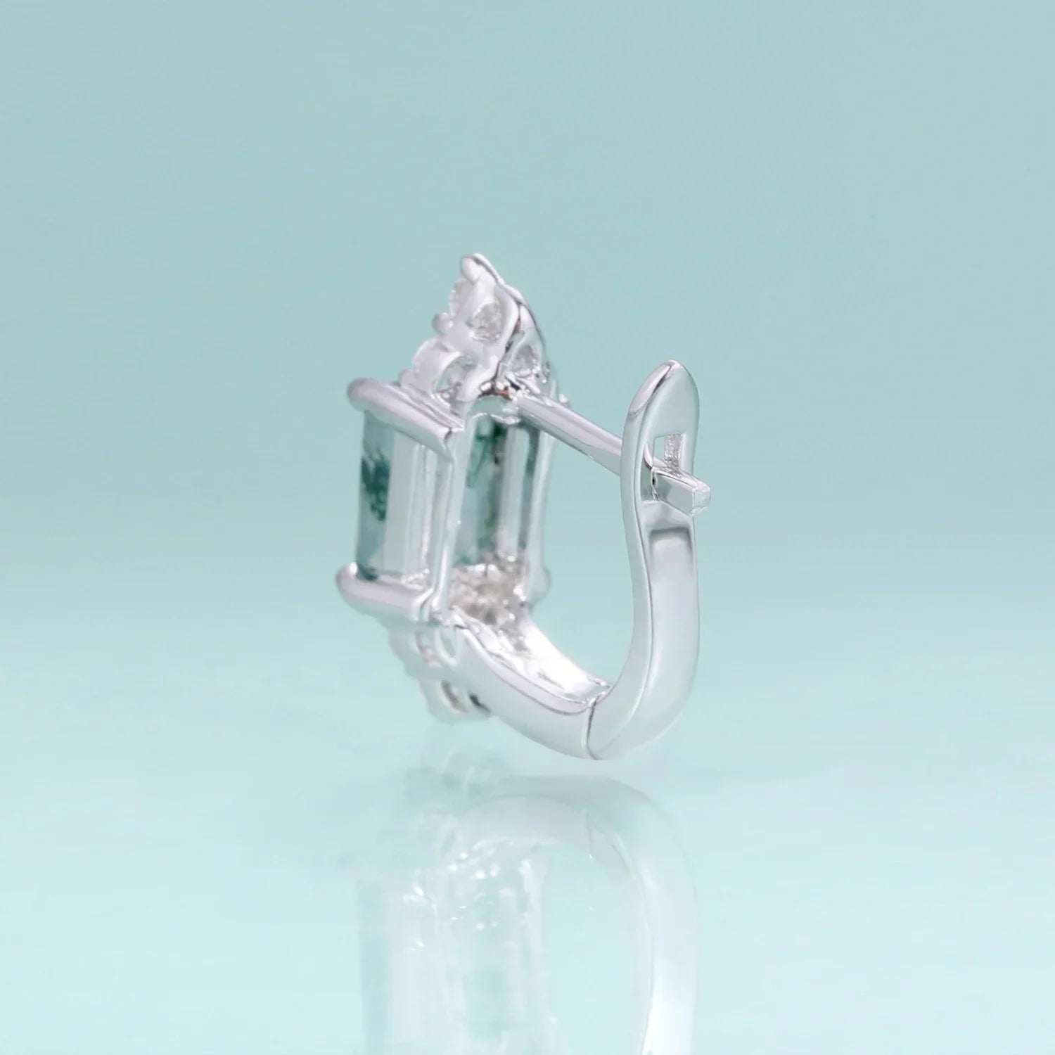 RosaryMilano silver fashion earring with gemstone detail on light blue background